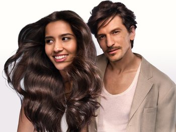 A woman with long dark brown hair and a man with similar hair color and style.