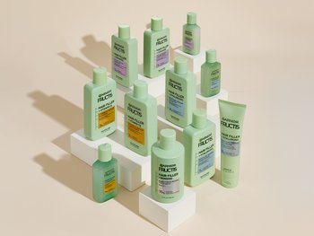 A group of green Garnier Fructis hair product bottles are displayed.