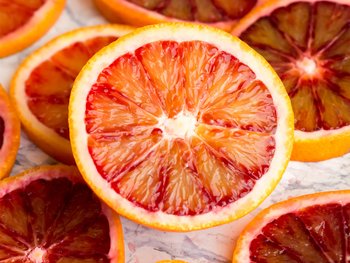 Slices of blood orange, a powerful ingredient in hair care that promotes healthy hair growth.