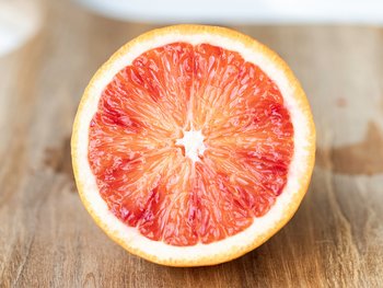 A sliced blood orange, an ingredient used in hair care that protects the hair with antioxidants.