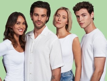 2 female and 2 male models smile with voluminous hair.