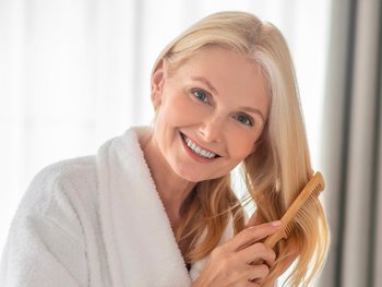 Woman using a comb to brush her hair