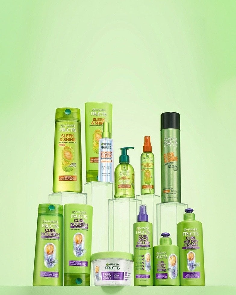 Green background and multiple Garnier products for hair care displayed in two rows.