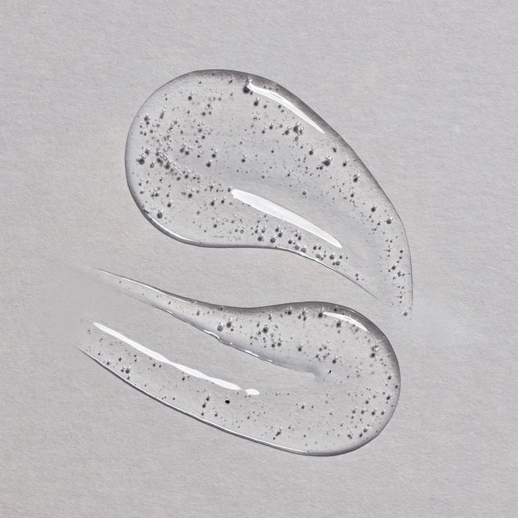 Micellar water with charcoal texture close-up