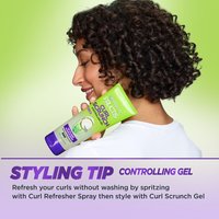 Styling tip: woman holding Curl Scrunch Gel.