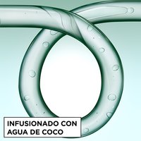 Close-up of a glass curl-shaped tube infused with coconut water bubbles, representing the hydrating ingredients in Garnier Fructis Curl Control Scrunching Gel.