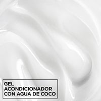 Macro texture shot of smooth, white Garnier Fructis Curl Shine Conditioning Jelly infused with coconut water for intense hair hydration.