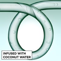 Close-up of a glass curl-shaped tube infused with coconut water bubbles, representing the hydrating ingredients in Garnier Fructis Curl Shape Defining Spray Gel.