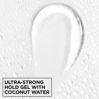 Macro texture shot of clear Garnier Fructis Curl Shape Defining Spray Gel with ultra-strong hold and moisturizing coconut water.
