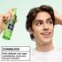 Styling tip for curly hair: man demonstrating the use of Garnier Fructis Curl Shape Defining Spray Gel by spraying once per section for buildable definition.