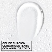 Macro texture shot of clear Garnier Fructis Curl Shape Defining Spray Gel with ultra-strong hold and moisturizing coconut water.