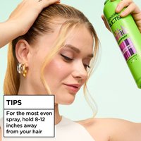 A close-up of a woman spraying the product. An overlay box reads "TIPS: For the most even spray, hold 8-12 inches away from your hair".