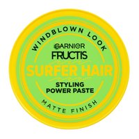A top-down view of the circular yellow lid of the Surfer Hair tub, showcasing the "WINDBLOWN LOOK," "MATTE FINISH," and branding.