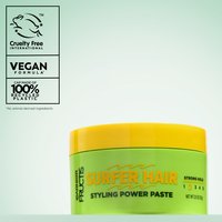 A product shot of the green and yellow Garnier Fructis Surfer Hair Styling Power Paste tub, featuring "Cruelty Free International," "VEGAN FORMULA," and "100% RECYCLED PLASTIC" logos on the left.