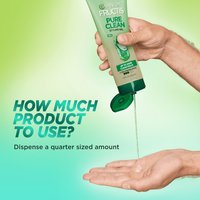 A bottle of Garnier Fructis Pure Clean Styling gel with product being dispensed on to someone's hand. Dispense a quarter sized amount of product for usage.