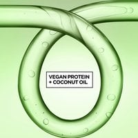 A stylized green liquid loop with bubbles, highlighting the ingredients "VEGAN PROTEIN + COCONUT OIL."