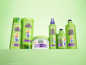 A collection of Garnier Fructis Curl Nourish hair products, including shampoo, conditioner, a flexi-hold curls product, curl knot melter, and curl air dry cream.