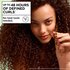 Defined curly hair results with Garnier Fructis: woman demonstrating up to 48 hours of definition without heat tools using the Curl Nourish hair care system.