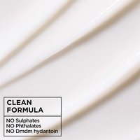 Clean hair care formula texture: macro shot of smooth, white Garnier Fructis Curl Nourish conditioner blended without sulphates, phthalates, or DMDM hydantoin.