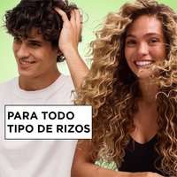 Inclusive hair care for all curl types: man and woman with diverse curly textures showcasing healthy, bouncy hair achieved with the Garnier Fructis styling line.