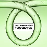 Green gel-textured rings with bubbles frame the text "Vegan Protein + Coconut Oil," highlighting Garnier Fructis Curl Refresher's key ingredients.