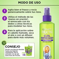 A "How to Use" infographic beside the Garnier Fructis Curl Refresher bottle outlines three steps: shake and spritz curls, use finger-coiling techniques to reshape curls, and air dry or diffuse for volume.