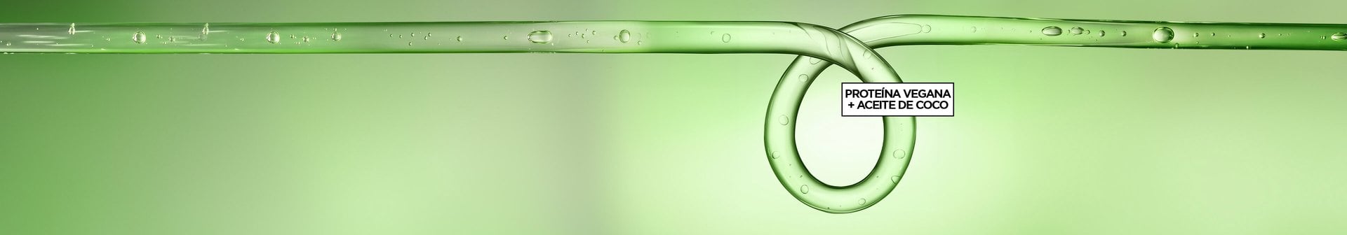 Wide-format promotional hero banner featuring a macro close-up of a translucent green liquid strand stretching horizontally across the frame, adorned with small water droplets along its surface, set against a soft gradient green background. Toward the right-center of the image, the liquid strand loops into a smooth, circular curl shape — visually referencing a defined curl pattern. Centered within the loop is a small black-outlined text box with bold black text reading: "VEGAN PROTEIN + COCONUT OIL," highlighting the key active ingredients of the Garnier Fructis Curl Nourish product line.