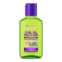 Front view of a lime-green multi-use curl oil bottle with a purple cap, labeled with coconut oil and vitamin E, promising 72% less breakage for all curl types.