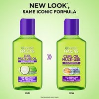 Side-by-side comparison of old and new curl multi-use oil bottle designs, announcing an updated look with the same 72% breakage-reduction formula for all curl types.