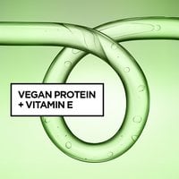 Close-up of a glossy green curl-shaped gel swirl formula, highlighting a formula infused with vegan protein and vitamin E.