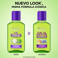 Side-by-side comparison of old and new curl multi-use oil bottle designs, announcing an updated look with the same 72% breakage-reduction formula for all curl types.