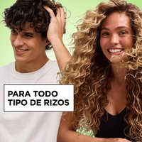 Smiling man and woman with healthy, defined curls showcasing hair care products formulated for all curl types.