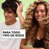 Smiling man and woman with healthy, defined curls showcasing hair care products formulated for all curl types.