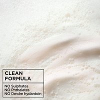 Texture shot of Garnier Fructis Curl Nourish clean formula lather: macro view of the rich, sulfate-free shampoo bubbles formulated without phthalates or DMDM hydantoin.