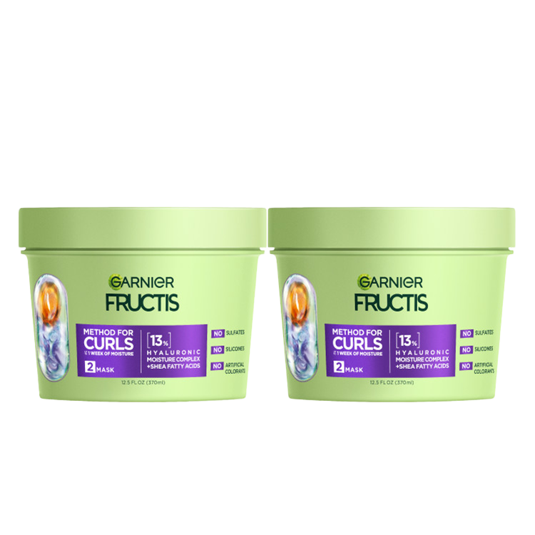 Two light green tubs of Garnier Fructis Method for Curls Mask are displayed. Each tub is labeled "METHOD FOR CURLS UP TO 1 WEEK OF MOISTURE," indicating it's a "MASK" with "13% HYALURONIC MOISTURE COMPLEX + SHEA FATTY ACIDS." It also states "NO SULFATES, NO SILICONES, NO ARTIFICIAL COLORANTS."