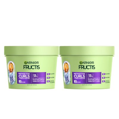 Two light green tubs of Garnier Fructis Method for Curls Mask are displayed. Each tub is labeled "METHOD FOR CURLS UP TO 1 WEEK OF MOISTURE," indicating it's a "MASK" with "13% HYALURONIC MOISTURE COMPLEX + SHEA FATTY ACIDS." It also states "NO SULFATES, NO SILICONES, NO ARTIFICIAL COLORANTS."