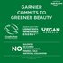 An informational graphic stating "GARNIER COMMITS TO GREENER BEAUTY," featuring logos for Cruelty Free International and "VEGAN FORMULA," and indicating "MADE IN A FACTORY USING 100% RENEWABLE ENERGY." It also prominently states "NO SULFATES SILICONES DRYING ALCOHOL MINERAL OILS ARTIFICAL COLORATNS." The "available at amazon" logo is in the top right.