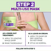 Garnier Fructis 'Step 2 Multi-Use Mask' shown with a hand holding curly hair. Instructions for use as a rinse-out treatment or a leave-in cream are provided.