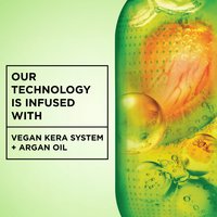 An abstract green capsule-like image containing orange and yellow bubbles, with text stating "OUR TECHNOLOGY IS INFUSED WITH VEGAN KERA SYSTEM + ARGAN OIL."
