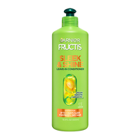A large green bottle of Garnier Fructis Sleek & Shine Leave-In Conditioner (16.9 FL OZ / 500ml), highlighting "VEGAN KERATIN + ARGAN OIL" and claiming SYSTEM FOR UP TO 3 DAYS SLEEK FOR FRIZZY, DRY HAIR.