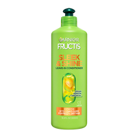 A large green bottle of Garnier Fructis Sleek & Shine Leave-In Conditioner (16.9 FL OZ / 500ml), highlighting "VEGAN KERATIN + ARGAN OIL" and claiming SYSTEM FOR UP TO 3 DAYS SLEEK FOR FRIZZY, DRY HAIR.