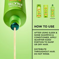 Close-up of a bottle of Garnier Fructis Sleek & Shine Leave-In Conditioner dispensing product on the left side. "How to use" section on the right side say: "After using Sleek & Shine shampoo and conditioner, apply quarter-sized portion to damp or dry hair. Distribute throughout hair. Do not rinse.". Featured products are shown at the top.