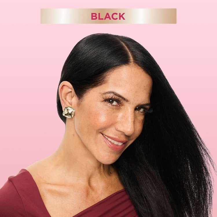 A smiling woman with long, smooth black hair, looking directly at the viewer. A banner at the top indicates 'BLACK,' suggesting a hair color result.