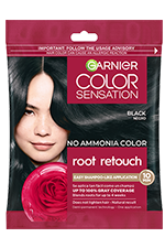 A small, single-use packet of Garnier Color Sensation Root Retouch in Black, featuring an image of a woman with dark hair and a red rose.