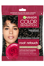 A single-use packet of Garnier Color Sensation Root Retouch in Dark Brown, featuring a woman with dark brown hair and a red rose.