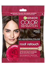 A single-use packet of Garnier Color Sensation Root Retouch in the Brown shade, featuring a woman with brown hair and a red rose.