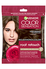 A single-use packet of Garnier Color Sensation Root Retouch in Light Brown, featuring a woman with light brown hair and a red rose icon.