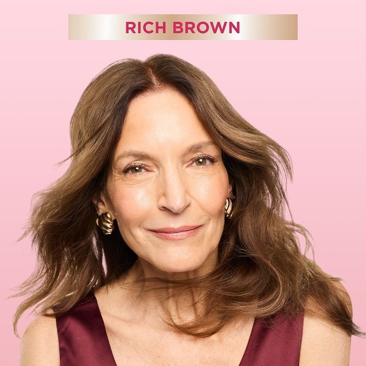 A smiling woman with mid-length, wavy rich brown hair, looking directly at the viewer. A banner at the top indicates ‘Rich Brown,' suggesting a hair color result.