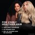 Two models, one with dark hair and one with light blonde hair, showcase visibly healthier, shiny hair after using Garnier Olia.