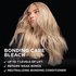 A woman with long, wavy, platinum blonde hair poses against a solid black background, looking slightly downward with a cool, confident expression. Overlaid white text on the left reads: "BONDING CARE BLEACH" followed by a bulleted claim list: "✓ Up to 7 Levels of Lift ✓ Repairs Weak Bonds ✓ Neutralizing Bonding Conditioner."